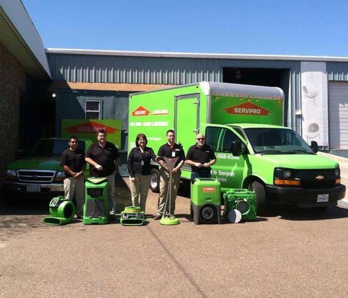 SERVPRO team proudly showcasing equipment and company vehices